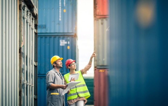 Workers Deciding On Which Shipping Container To Build a BarTainer Out Of 