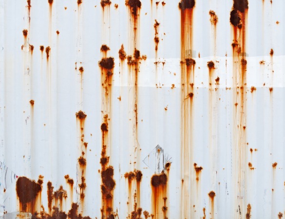 White shipping container with rusty spots